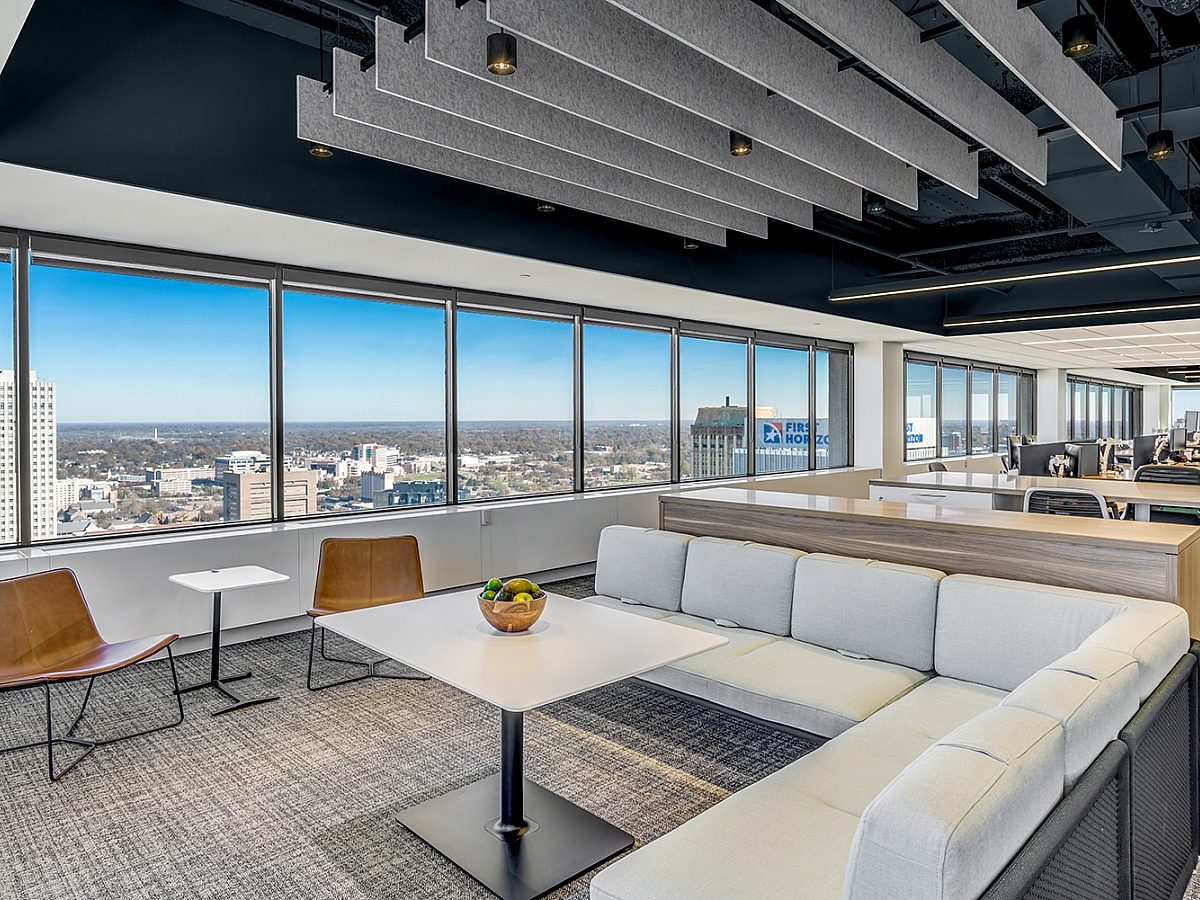 Image of an office building with a large window overlooking a city and booth seating