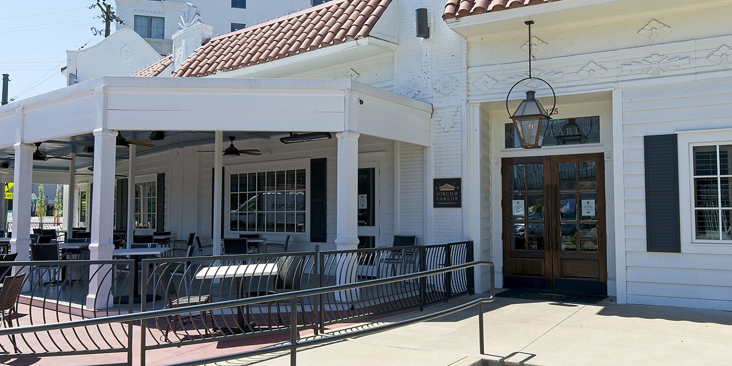 Exterior view of a white building of Porch and Parlor restaurant